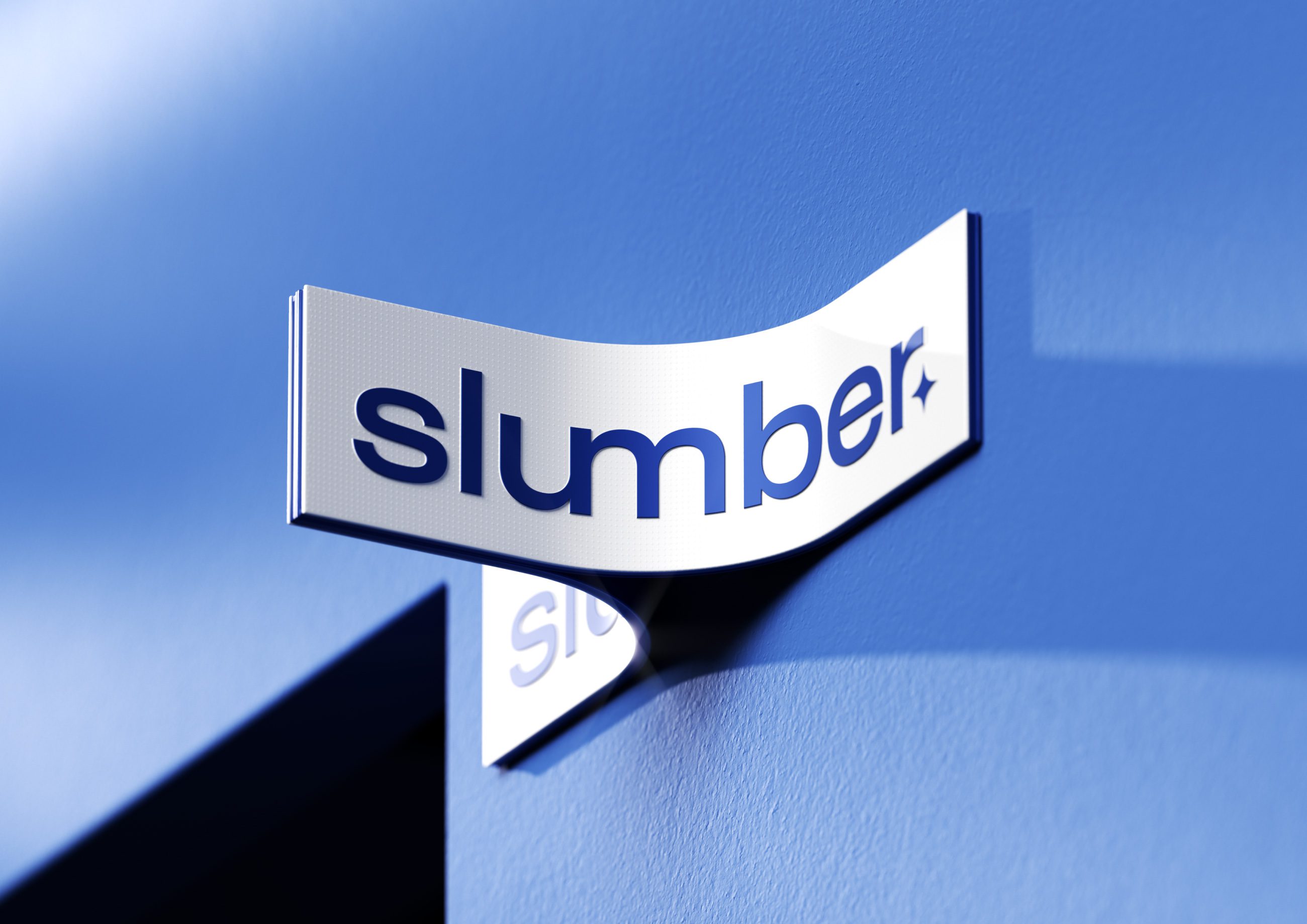 Curved metal Slumber sign mounted on a blue wall