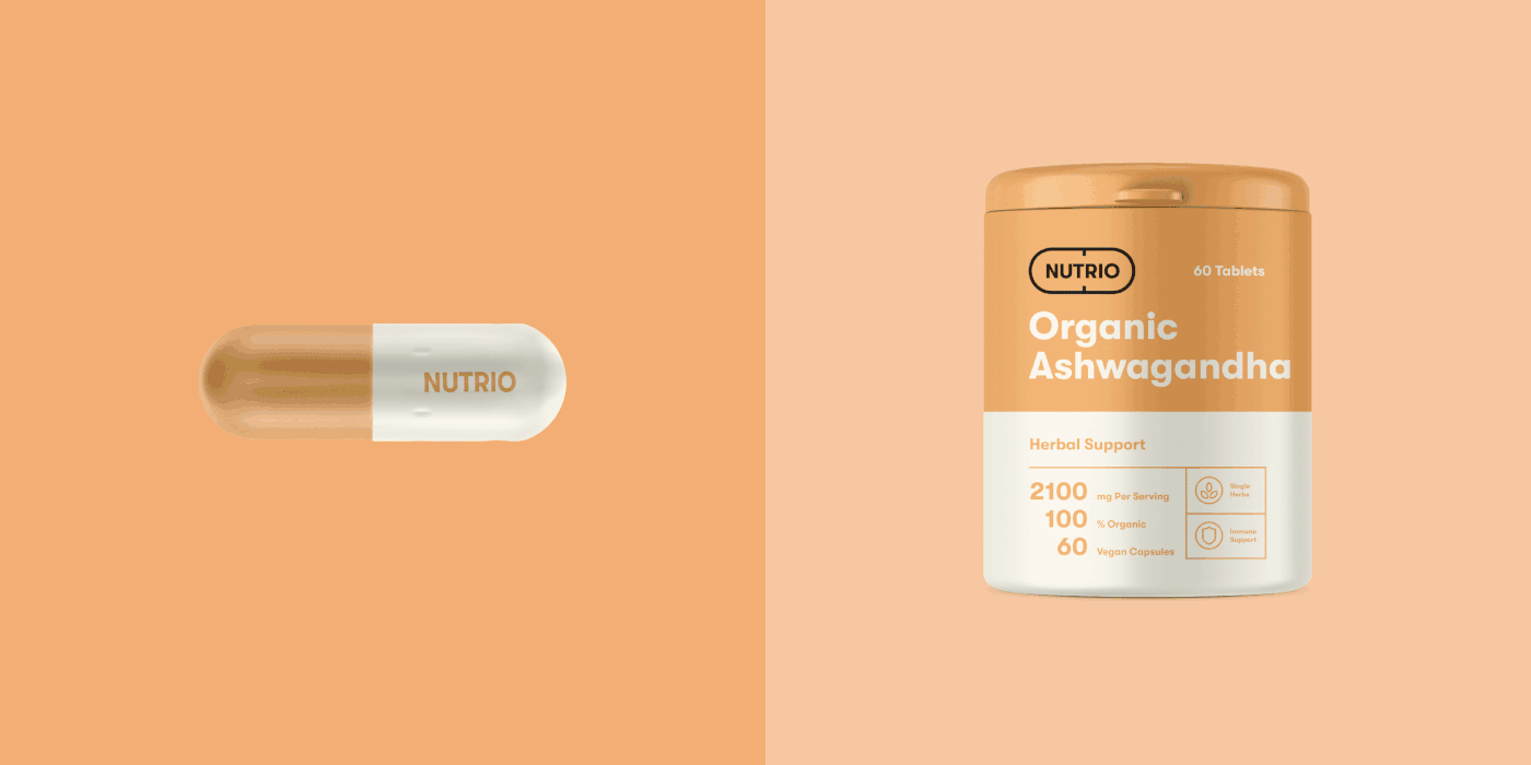 Nutrio capsule and orange Ashwagandha tub on a two tone orange panel