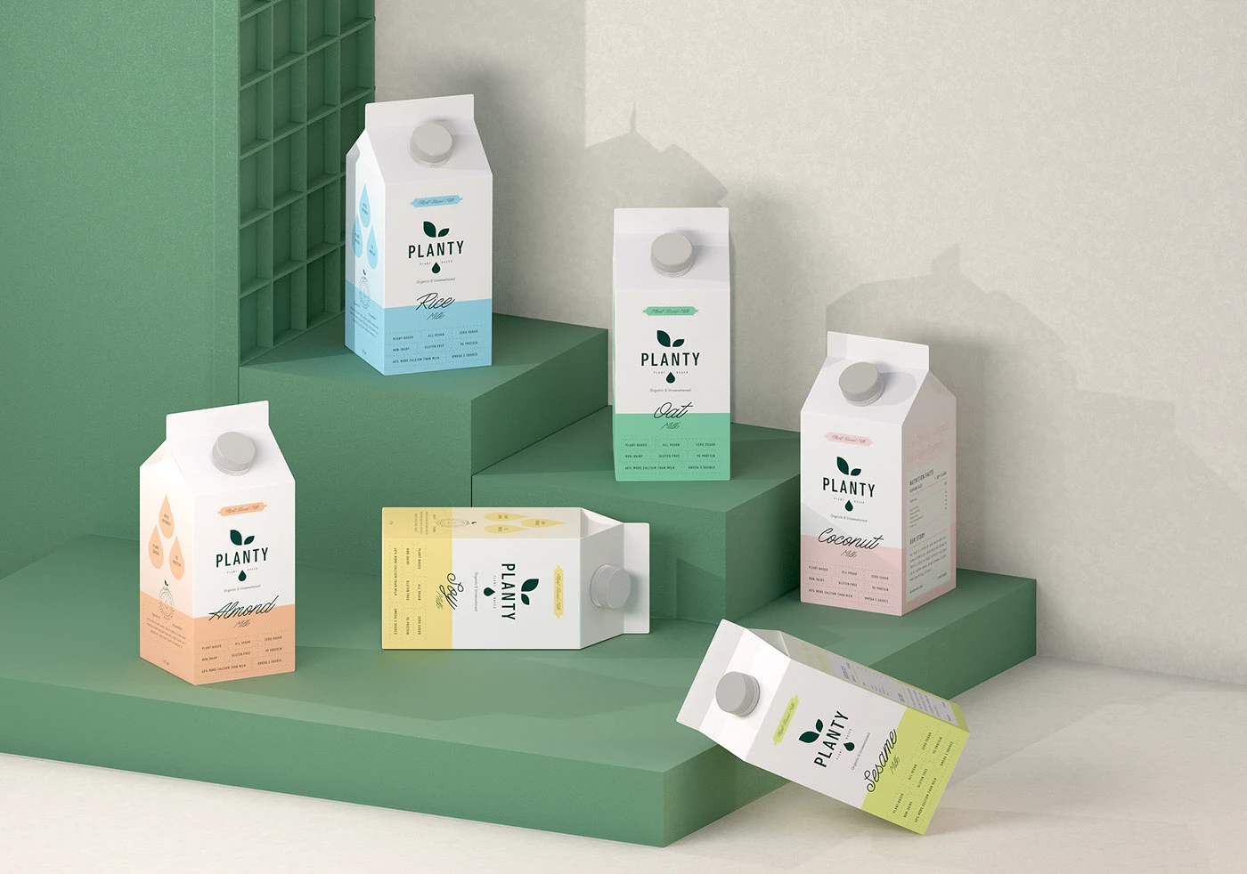 Six Planty cartons in flavour colors arranged across green steps in daylight