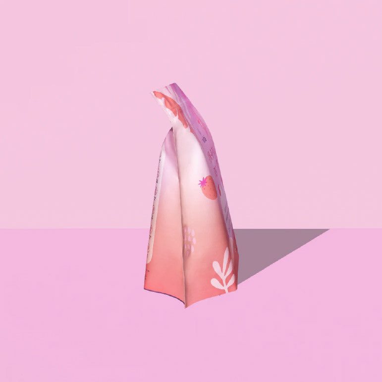 Milksta pouch seen edge on, folded, casting a long shadow on pink