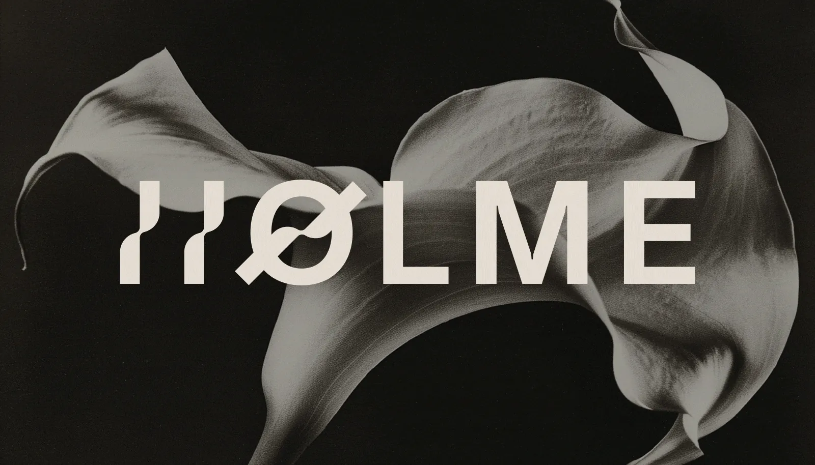 Holme wordmark set across a black and white petal on dark ground