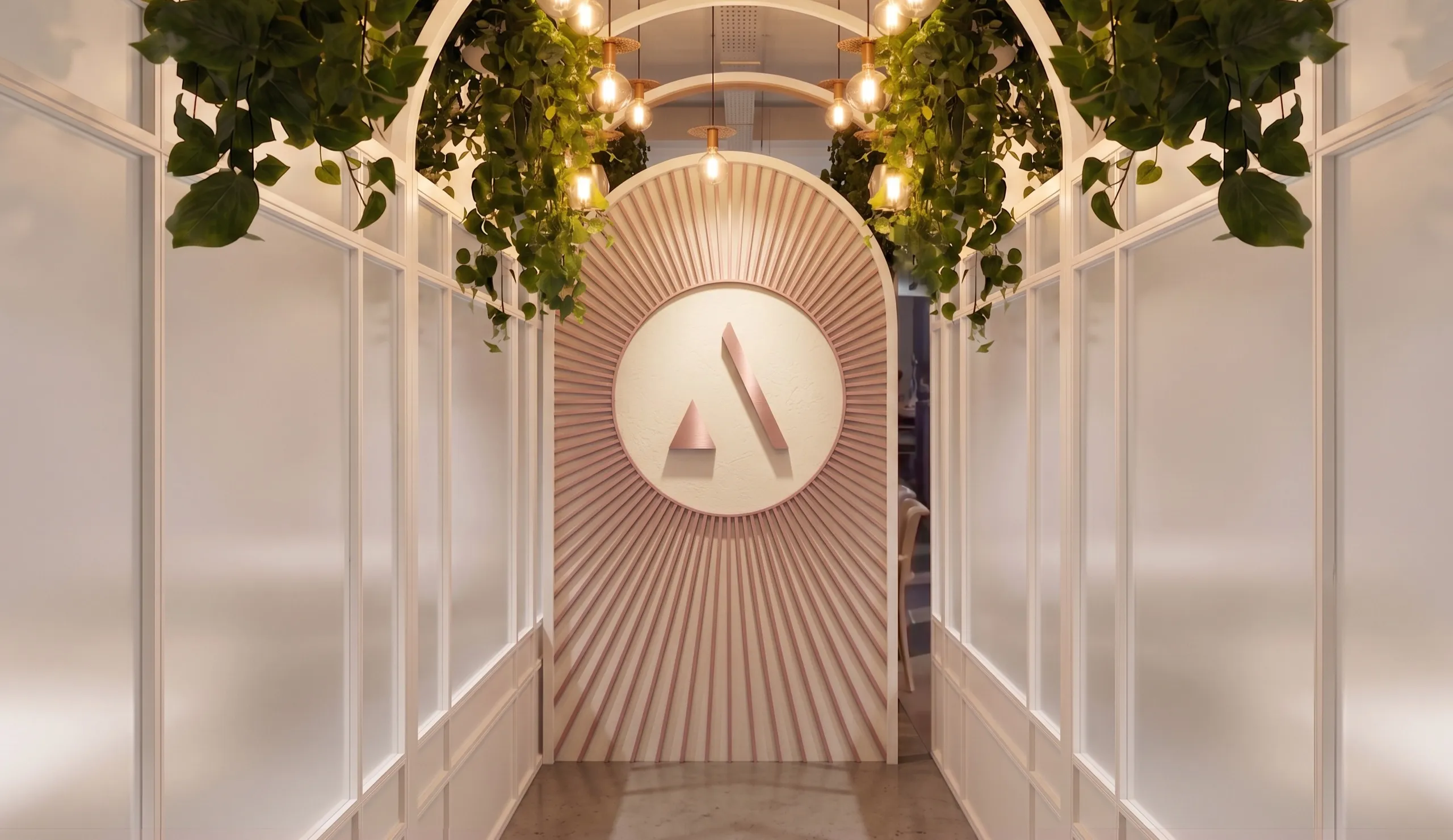 Arched entrance with the Alici's monogram under hanging greenery