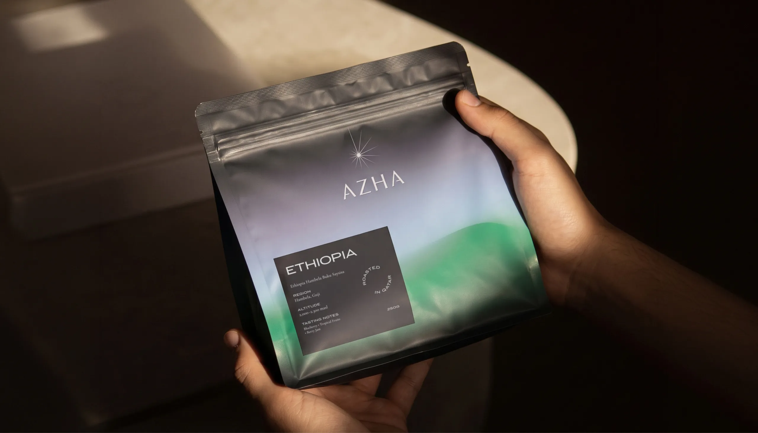 Hand holding an AZHA Ethiopia coffee bag